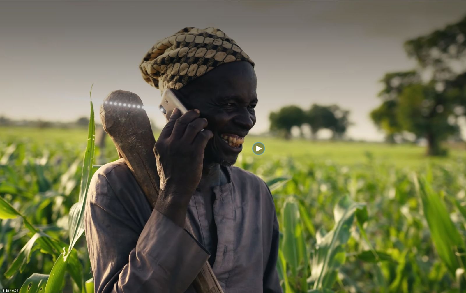Helios Towers documentary video still, a farmer on a phone call in a cornfield.